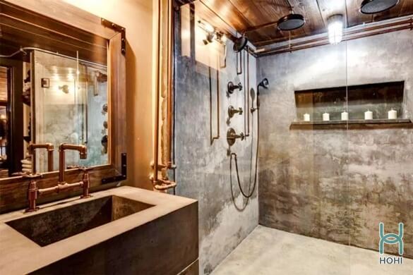 nhà vệ sinh phong cách nội thất industrial với tường, nền xám xi măng, nội thất bê tông.