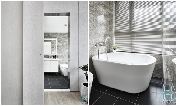 nội thất phòng tắm chung cư tối giản, hiện đại với gạch sàn màu đen và gạch ốp tường vân đá. 
